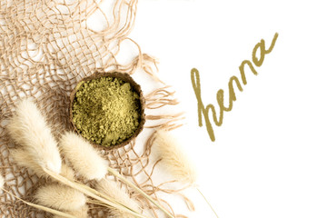 henna powder for dyeing hair and eyebrows and drawing mehendi on hands,  with green palm leaf