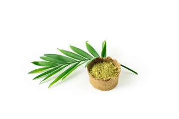 henna powder for dyeing hair and eyebrows and drawing mehendi on hands,  with green palm leaf