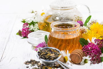 fresh flower honey, tea and ingredients on white wooden background