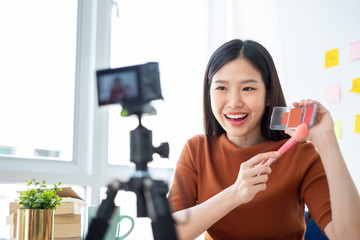 Asian woman beauty blogger/vlogger teaching for make up cosmetic tutorial via internet online...
