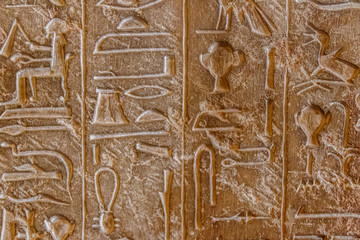 Ancient egyptian hieroglyphs carved on the stone wall