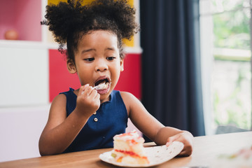 african girl kid eating sweet cake - Powered by Adobe