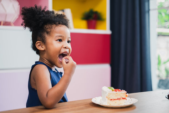 african girl kid eating sweet cake
