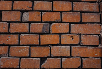 a crumbling red brick wall brick background.