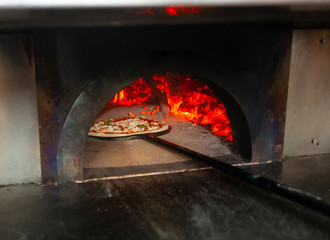 Pizza margherita in a wood oven.
