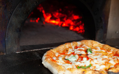 Pizza margherita in a wood oven.