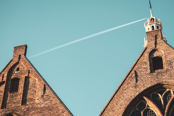 Church's roof and plane trail above the roof of the church