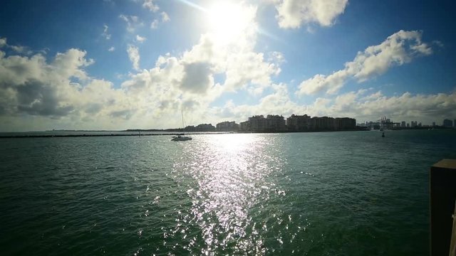 Boat in Miami Beach bayfront at sunset. Southern Florida, USA. Pan camera movement