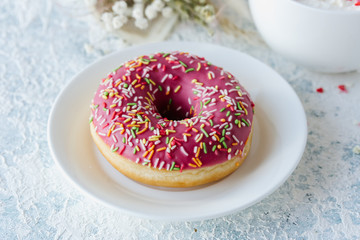 Berry pink donut on a plate. Top view