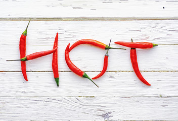 Hot red pepper on a white wooden vintage background.