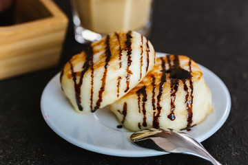 Cheesecakes on a dish on a dark background