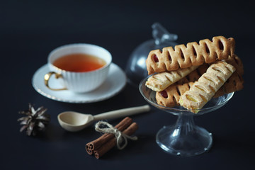Set for breakfast. Sweets and pastries with nuts for tea on a black background. A coffee cup and...