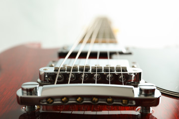 Beautiful six - string electric guitar on white background, closeup