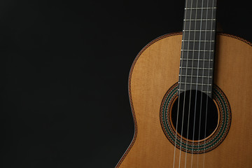 Obraz premium Beautiful six - string classic guitar against dark background, space for text
