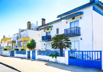Fototapeta na wymiar Costa Nova, Portugal: white houses with blue and yellows details in facade