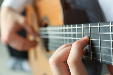 Fototapeta premium Man playing on classic guitar, space for text