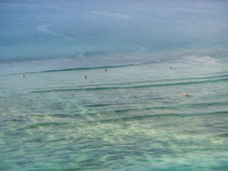 Boat and surfers on the waves. Bali.