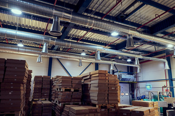 Warehouse with modern ventilation system full of raw material.