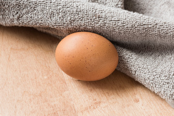 brown eggs on a wooden kitchen table.