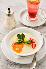 Oatmeal with strawberries and oranges. Healthy breakfast