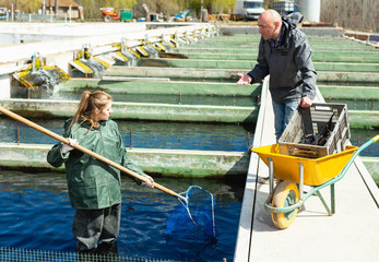 Male and female fish farm workers