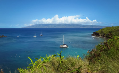 Panoramic view of boats in bay, blue ocean, blue sky, green shore, paradise in Maui, Hawaii