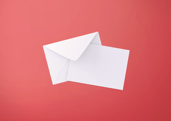 White postcard and envelope on background, top view. Blank envelope mockup and letterhead presentation template. Postcard flyer for your design.