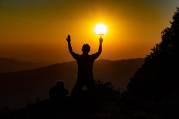 Silhouette of woman praying with cross in nature sunrise background, Crucifix, Symbol of Faith. Christian life crisis prayer to god.