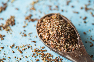 vintage spoon with lineseeds, blue background
