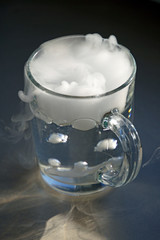 The origin of the storm in a glass of water. A cup of water  Sunlight. Shadows and highlights.