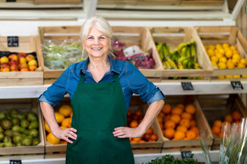 Senior woman working in small grocery store