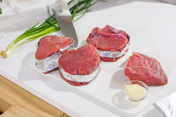 Cooking at home and preparing meat stake from pork or beef or lamb, in white modern light kitchen. Chef making steak meat for preparing dinner	