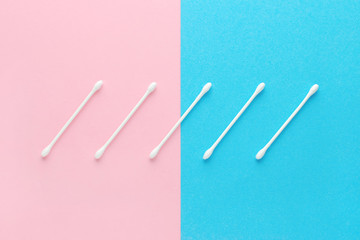 white cotton swabs on pink and blue background