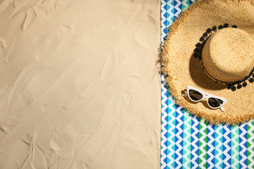 Flat lay composition with beach objects and space for text on sand