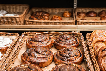 Wicker trays with different sweet buns in bakery