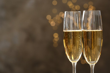 Glasses of champagne on blurred background, closeup. Space for text - obrazy, fototapety, plakaty
