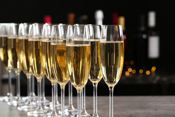 Many glasses of champagne on blurred background, closeup