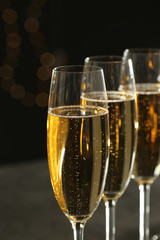 Many glasses of champagne on blurred background, closeup
