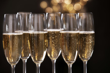 Many glasses of champagne on blurred background, closeup