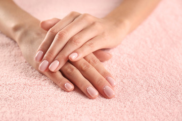 Closeup view of beautiful female hands on towel, space for text. Spa treatment