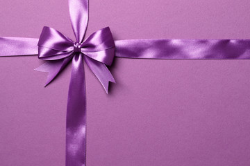 purple bow and ribbon isolated on purple background
