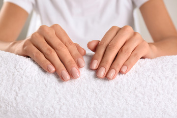 Obraz na płótnie Canvas Closeup view of beautiful female hands on towel. Spa treatment