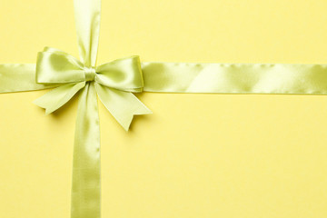 light green bow and ribbon isolated on yellow background