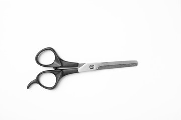 New thinning scissors on white background, top view. Professional hairdresser tool