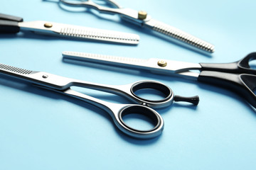 Scissors on color background, closeup. Hairdresser tools