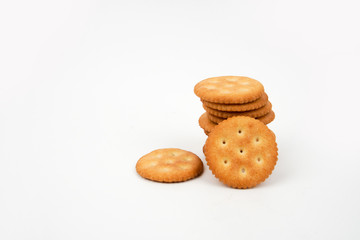 Stack of salted biscuits isolated on white background.