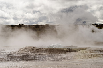 Geothermal area with strong steam outlet, center of a basin where hot water bubbles, mineral...