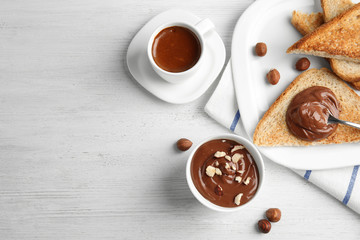 Sweet chocolate mousse and coffee served on wooden table, flat lay. Space for text