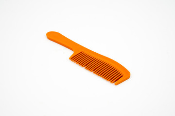 Orange color comb isolated on white background