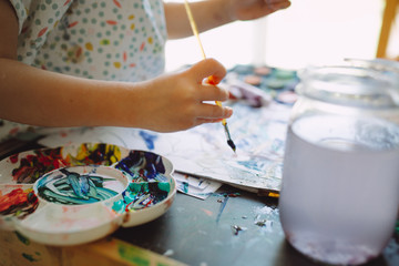 Fototapeta na wymiar Little girl painting at home
